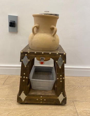 Pottery water pitcher with spout and decorative wood base